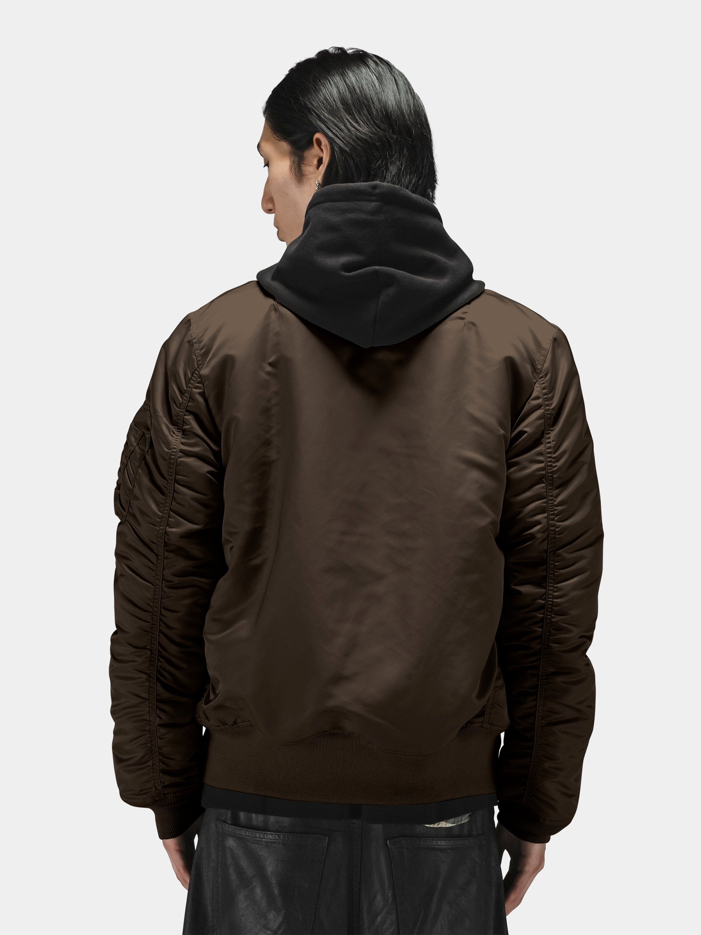 Alpha Industries MA-1 Bomber Jacket in brown over black hooded sweatshirt.