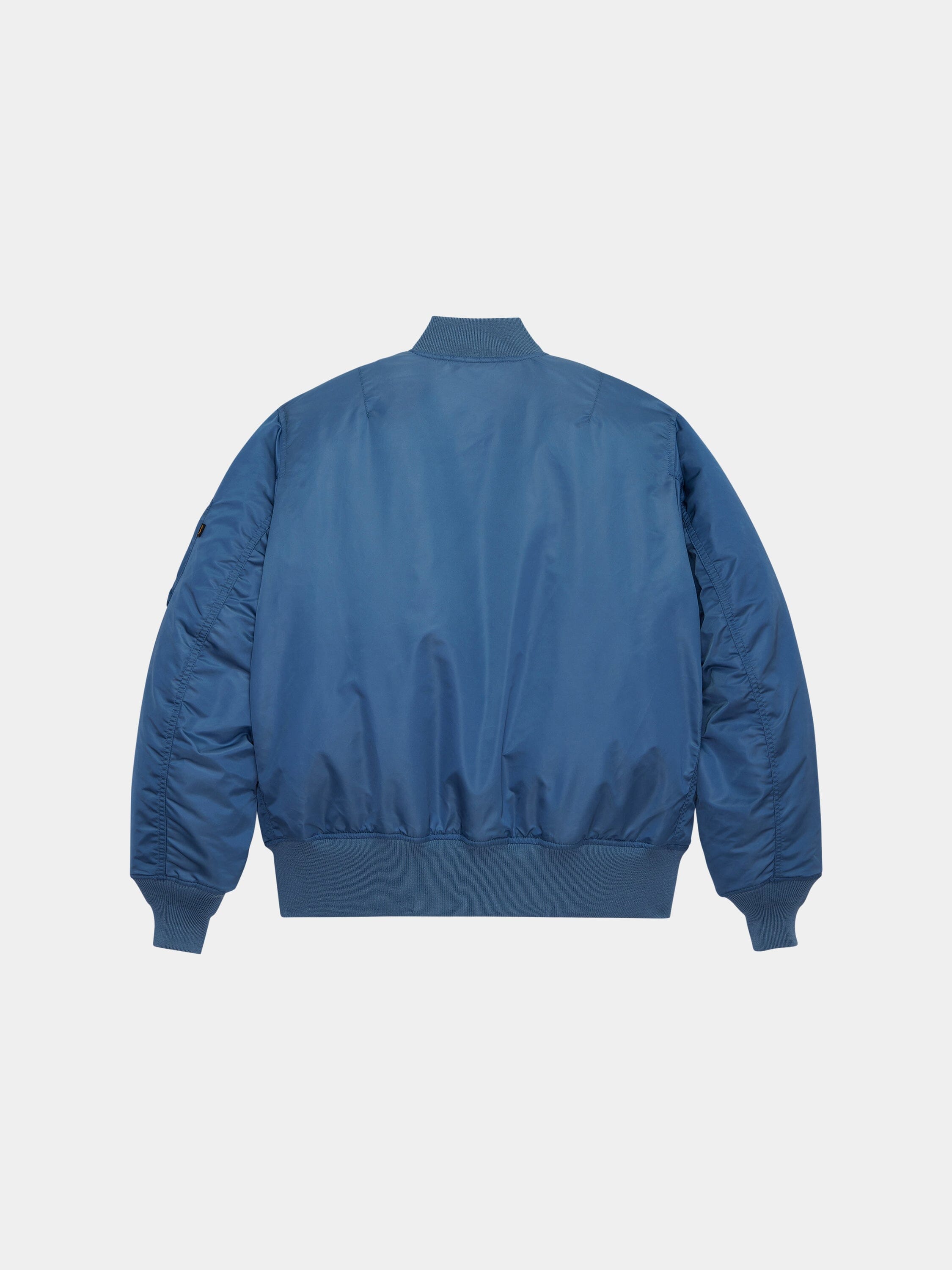 Alpha Industries MA-1 Bomber Jacket in blue with ribbed cuffs, waistband, and collar.