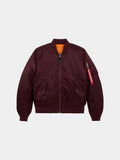 Front flat-lay view of cedar red Alpha Industries MA-1 Bomber Jacket Slim Fit showing ribbed collar, sleeve pocket with red tag, and orange lining at collar.