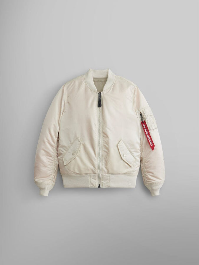 Alpha Industries MA-1 Bomber Jacket W in Limestone with front pockets, ribbed cuffs and hem, and red Remove Before Flight sleeve tag.