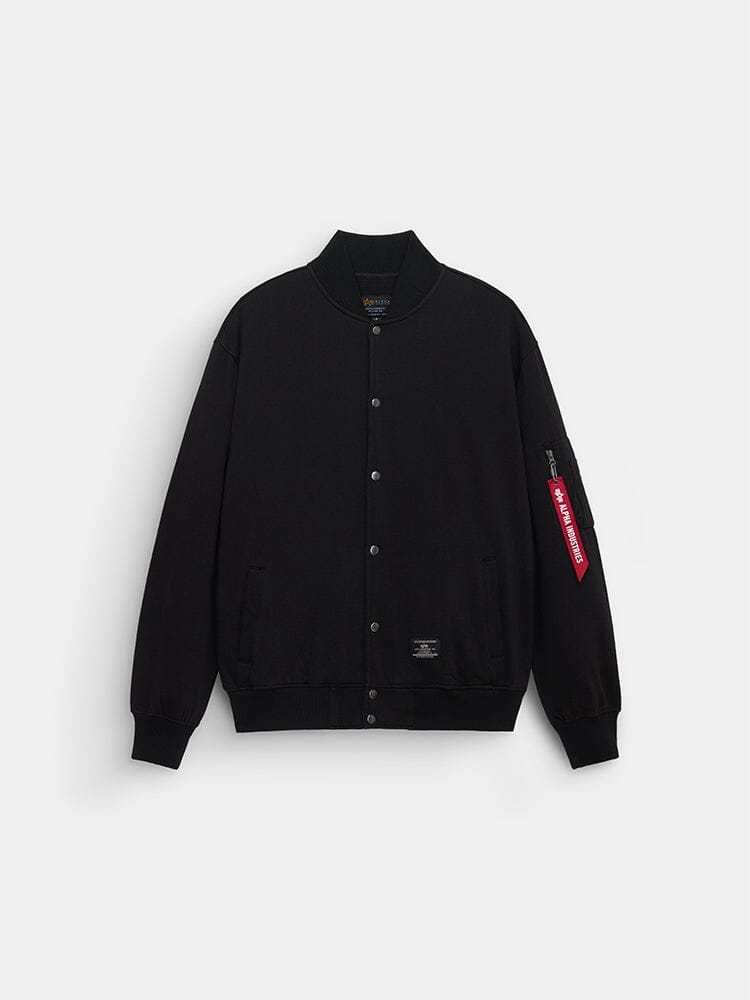 Alpha Industries MA-1 Fleece Jacket in black with snap buttons, ribbed collar and cuffs, two front pockets, red sleeve tag.
