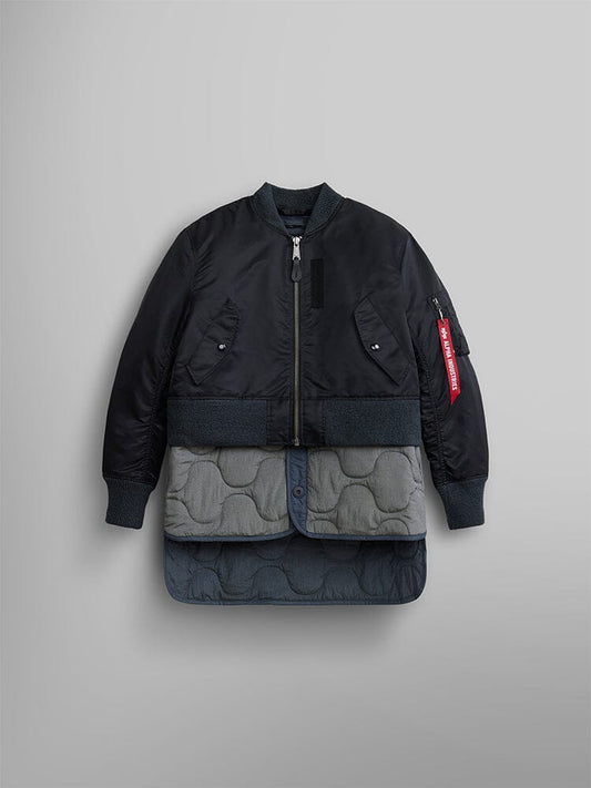 The Women's 3-in-1 MA-1 Quilted Liner by Alpha Industries, in black, is featured over an onion-quilted grey coat with button details, highlighting its versatile 3-in-1 style.