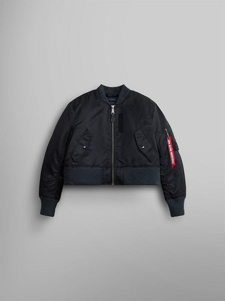 The Women's 3-in-1 MA-1 Quilted Liner by Alpha Industries features a black bomber jacket with a zip-up front, ribbed cuffs and hem, and a distinctive red tag on the left sleeve.