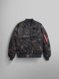 Alpha Industries MA-1 Mod Bomber Jacket with dark camo print, ribbed cuffs and hem, front zipper, water-resistant fabric, sleeve utility pocket, red Remove Before Flight tag.