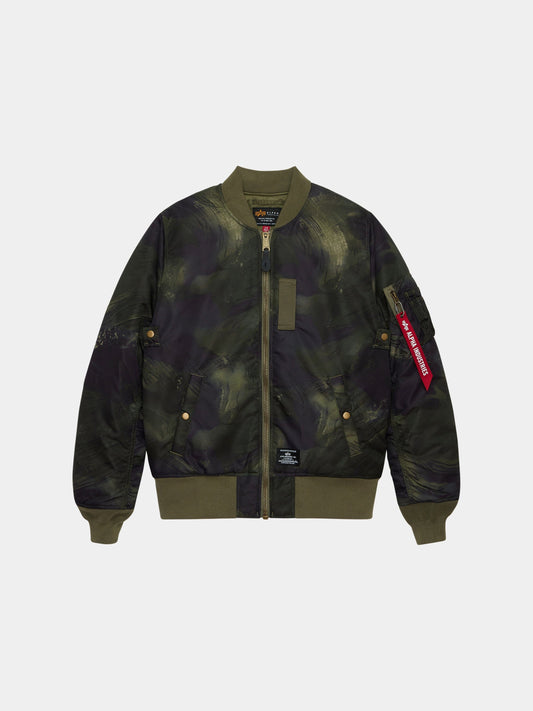Alpha Industries MA-1 Mod Bomber Jacket in olive rd camo with camouflage print, front zipper, ribbed cuffs, side pockets, utility pocket, red Remove Before Flight tag.
