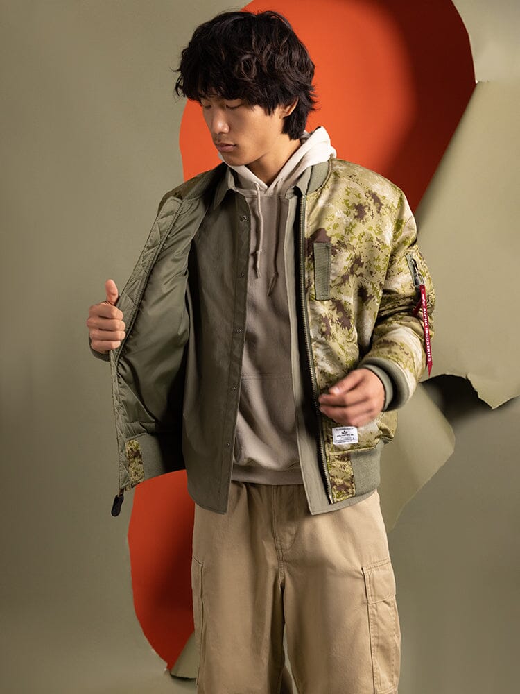 Alpha Industries MA-1 Mod Bomber Jacket, nylon material, front zipper closure, olive green color.