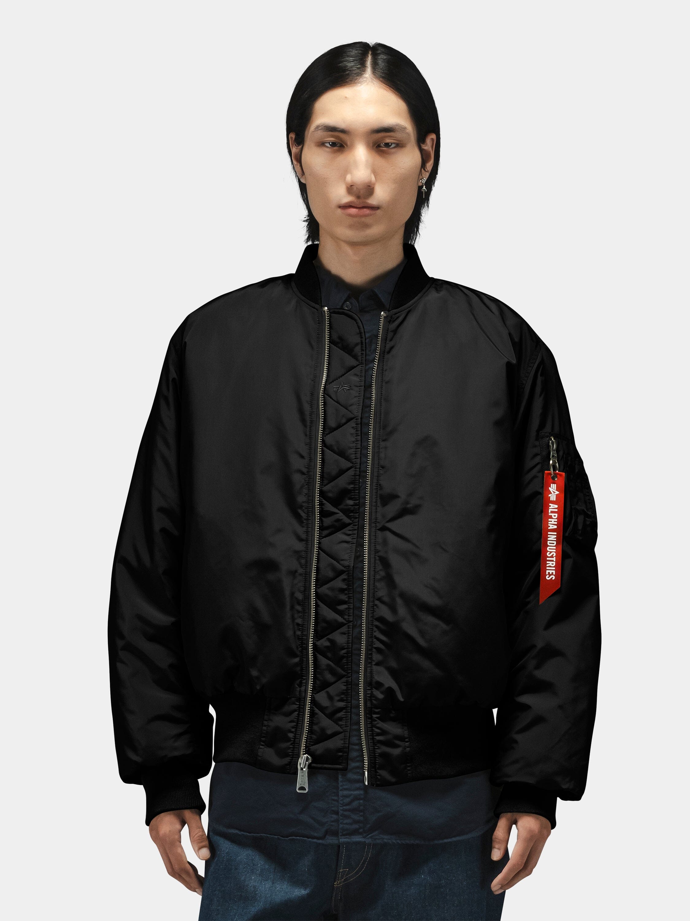 Alpha Industries MA-1 Oxford Flight Jacket, black with visible red tag on sleeve.