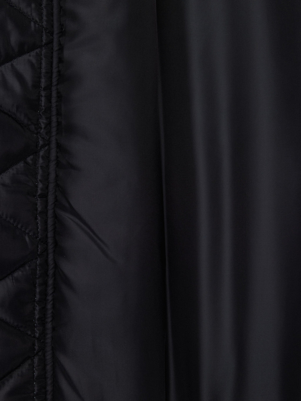 Alpha Industries MA-1 Oxford Flight Jacket, black oxford nylon with quilted pattern left, smooth finish right, visible stitching.