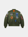 Alpha Industries MA-1 Squadron Bomber Jacket in sage with squadron patches and a red Remove Before Flight tag on the left sleeve.