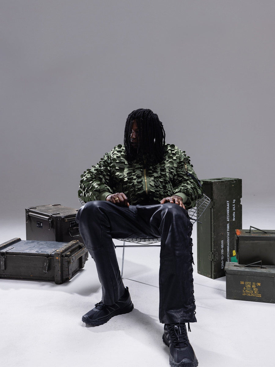 Alpha Industries MA-1 ULCANS Flight Jacket in green, black pants.