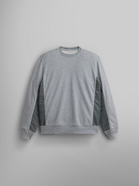 The Mixed Media Crewneck Sweatshirt by Alpha Industries, in Medium Charcoal Heather with darker side panels, is elegantly displayed, highlighting its French terry fabric.