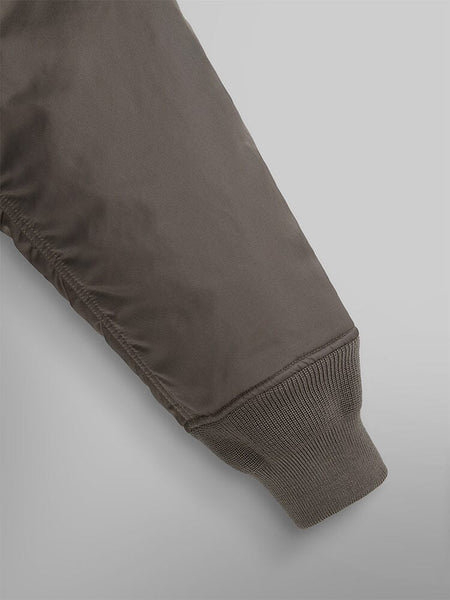 Close-up of a sleeve from the Alpha Industries Mixed Media Quilted Utility Jacket, featuring ribbed cuffs in coyote brown.