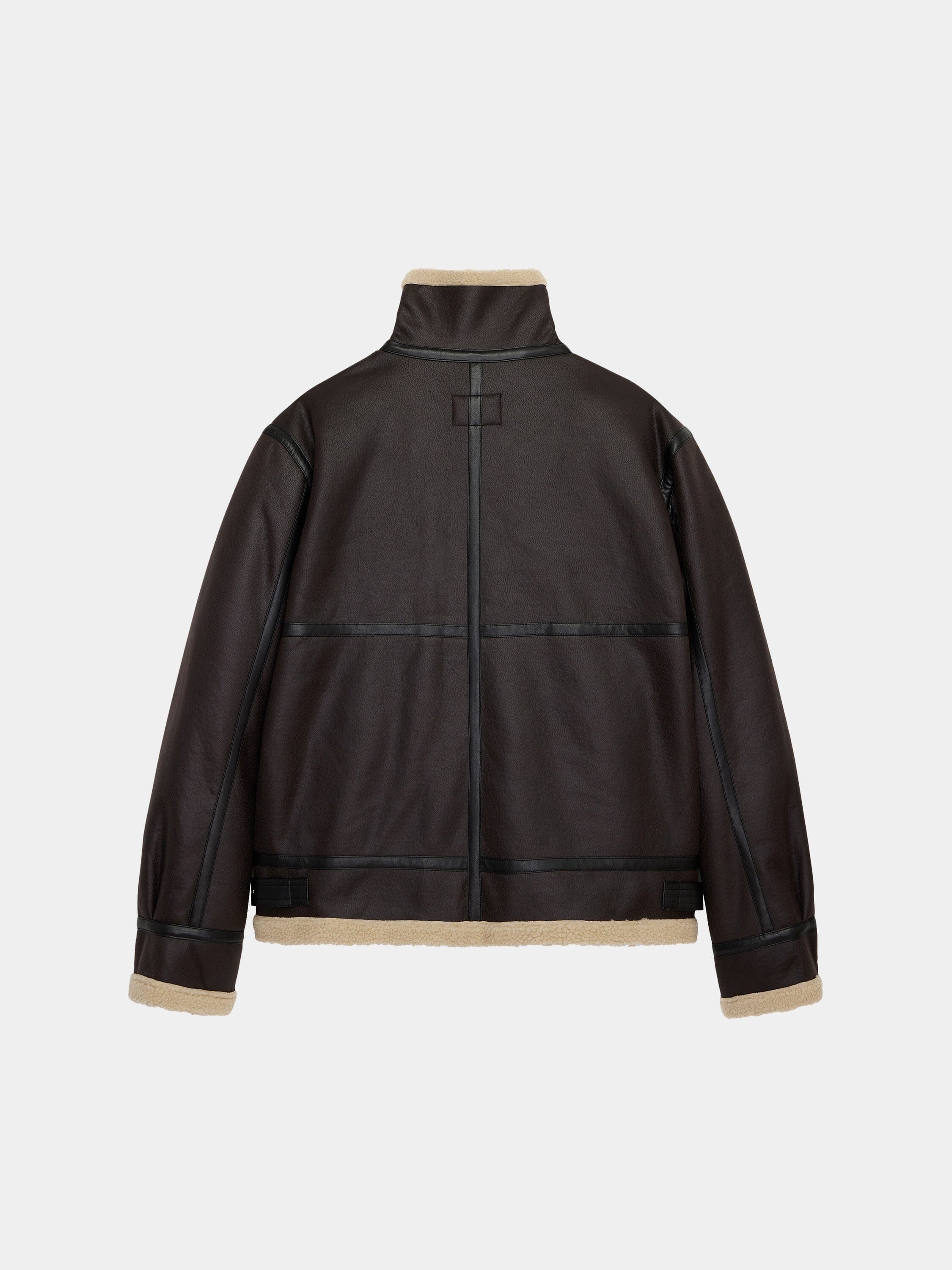 Alpha Industries Mouton B-3 jacket with black seam detailing, high collar, and tan shearling trim.