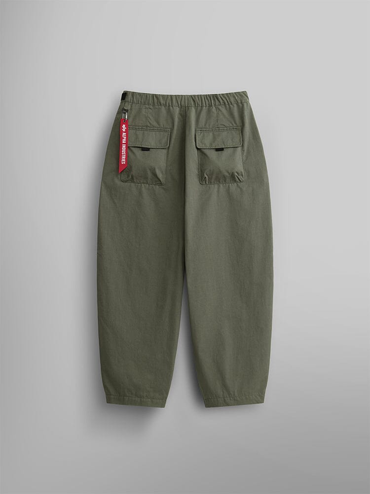 Oversized Tactical Pant by Alpha Industries, highlighted by their elastic waistband, two back pockets, and a distinctive red tag with white text on the right.