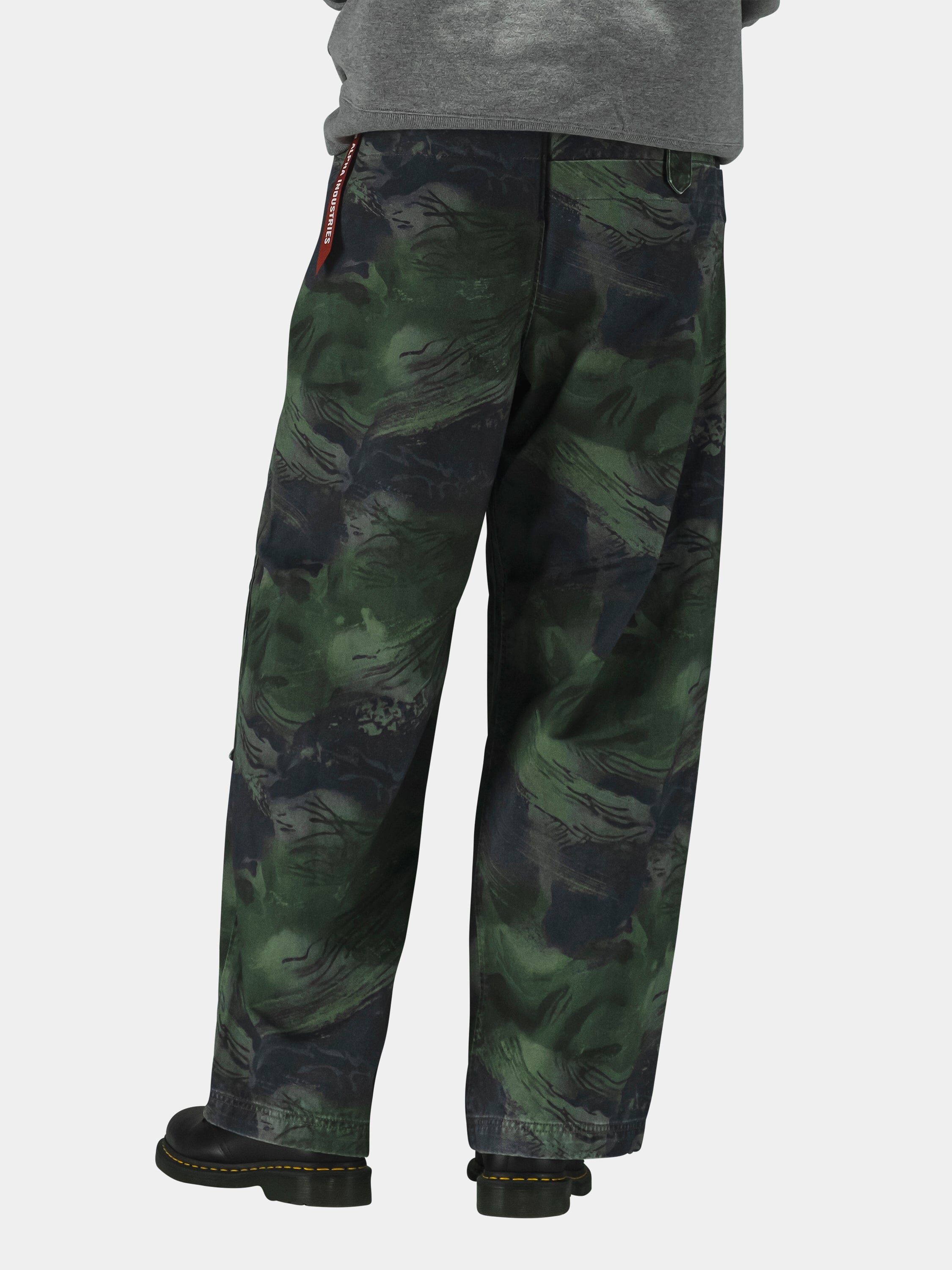 Alpha Industries Oversized Washed Pant in camo pattern with military design; black boots and gray top.