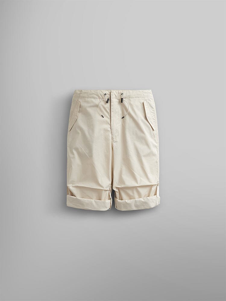 Alpha Industries Lightweight Parachute Pant in beige, nylon and cotton blend, adjustable drawstring waist, side pockets, rolled-up cuffs.