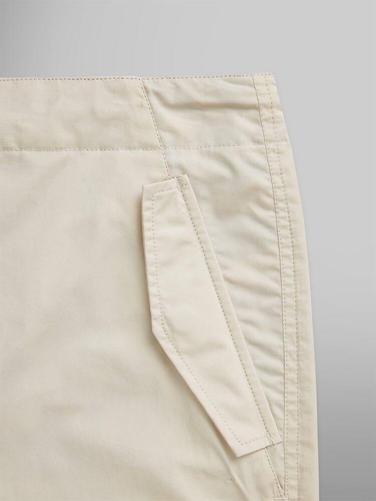 Alpha Industries Lightweight Parachute Pant in beige nylon/cotton blend with slanted side pocket and visible stitching.