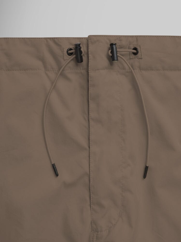 Alpha Industries Lightweight Parachute Pant brown nylon/cotton blend waistband with drawstring and black plastic toggles.