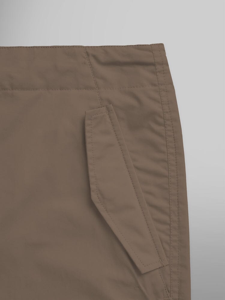 Alpha Industries Lightweight Parachute Pant in brown nylon/cotton blend with slanted side pocket and visible stitching.