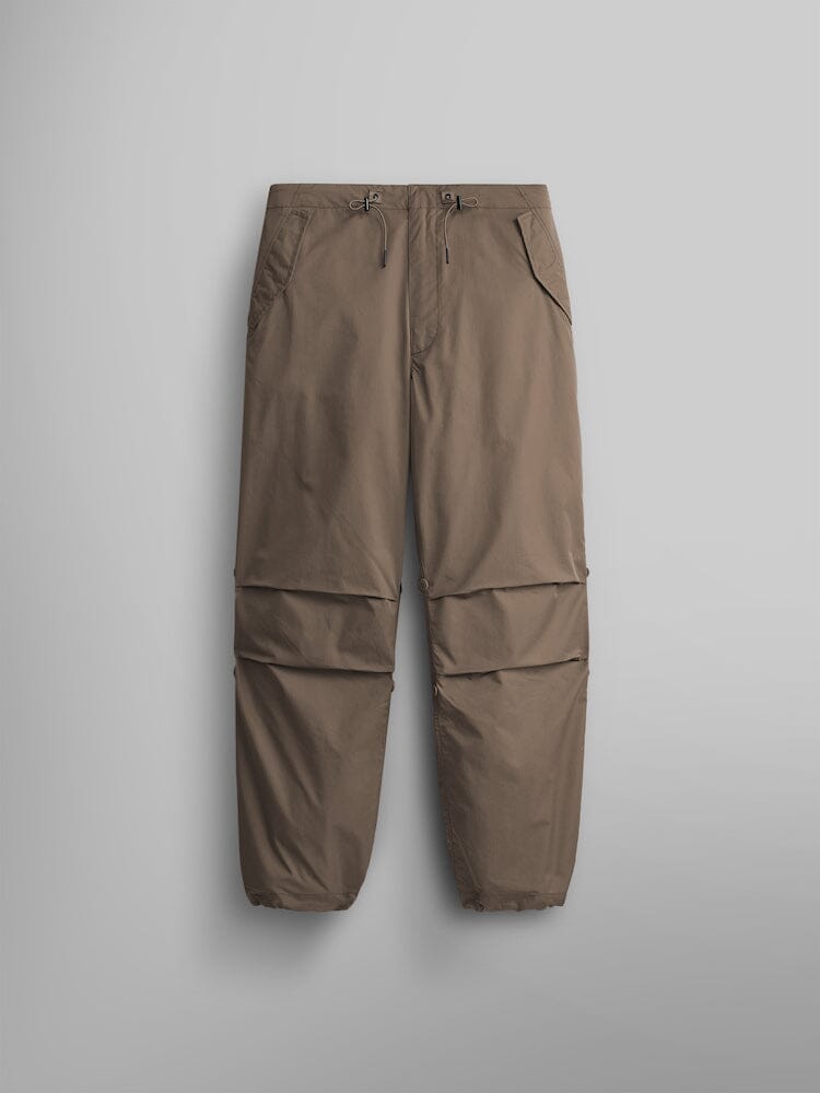 Alpha Industries Lightweight Parachute Pant in nylon/cotton blend with elastic cuffs, front drawstring waist, and multiple pockets.