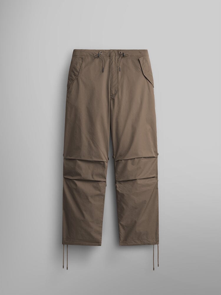 Alpha Industries Lightweight Parachute Pant, Coyote Brown, nylon/cotton blend, straight-leg fit, drawstrings at waist and ankles, visible knee seams.