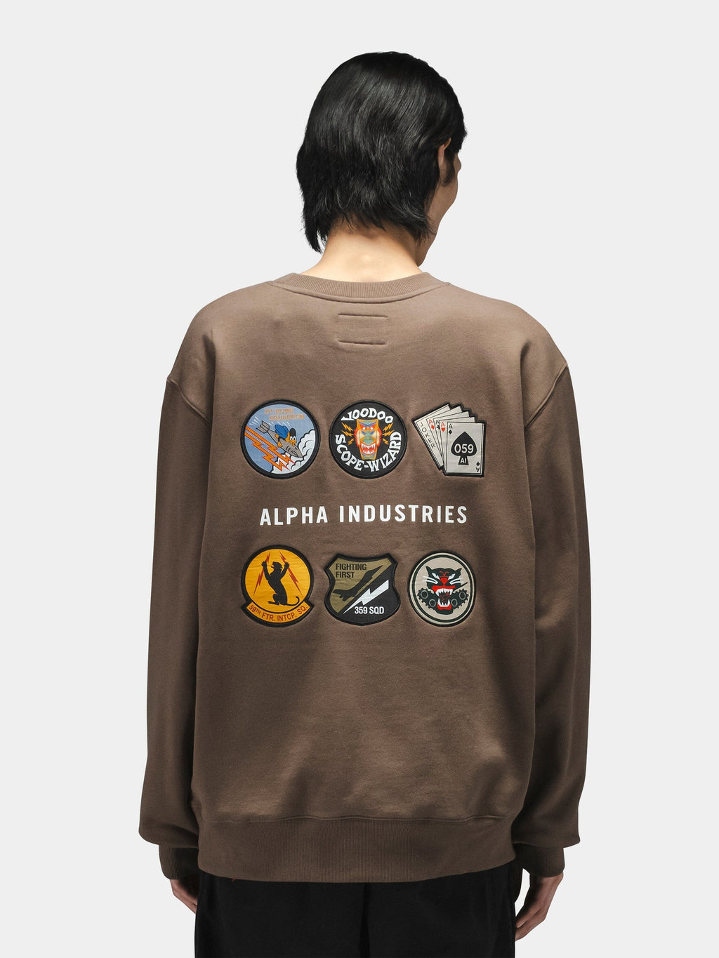 Alpha Industries Patched Crewneck, brown cotton-poly sweatshirt with embroidered patches and white text on back.