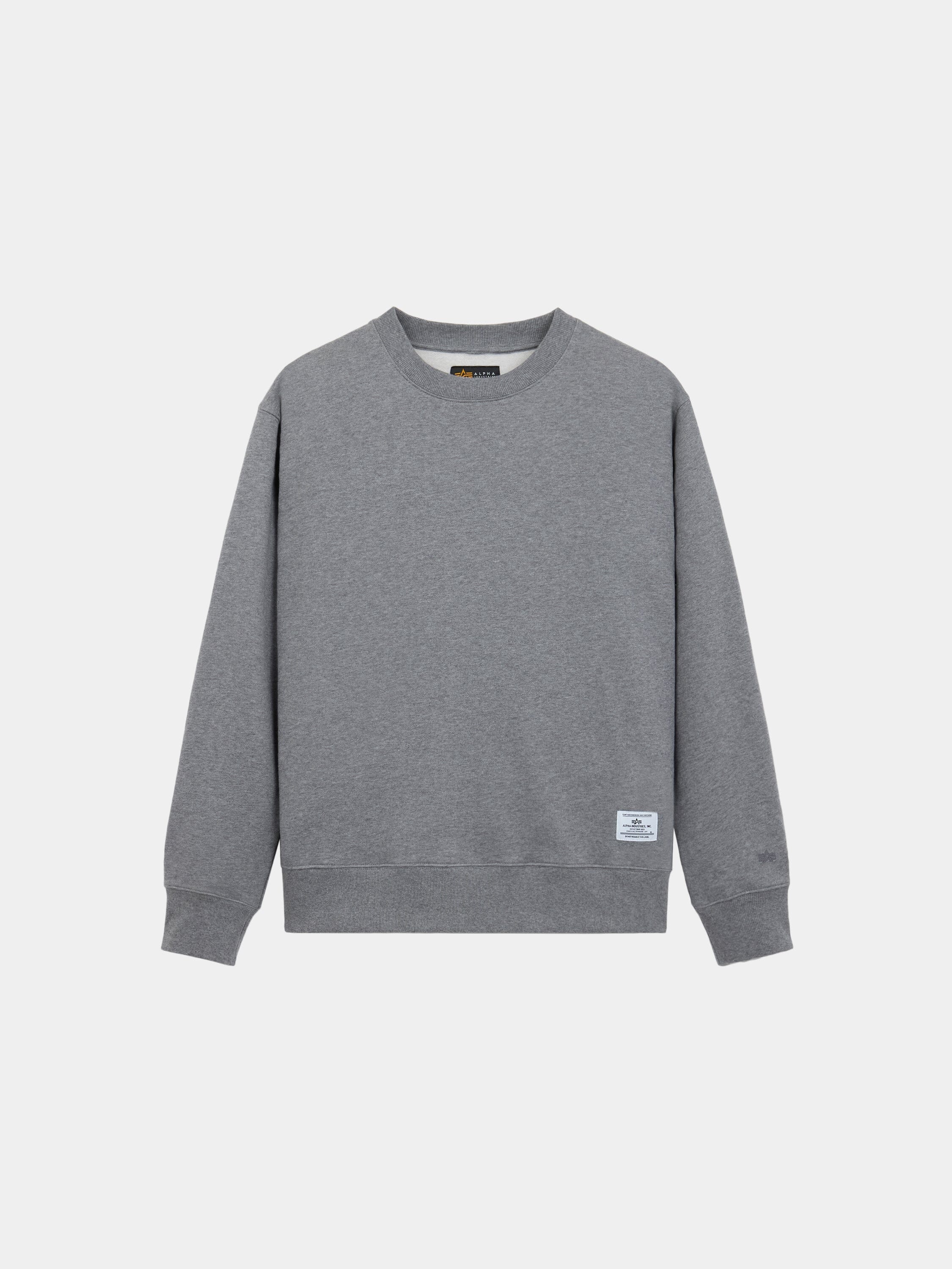 Alpha Industries Patched Crewneck, grey long-sleeve sweatshirt with small white label near hem, soft cotton-poly blend.