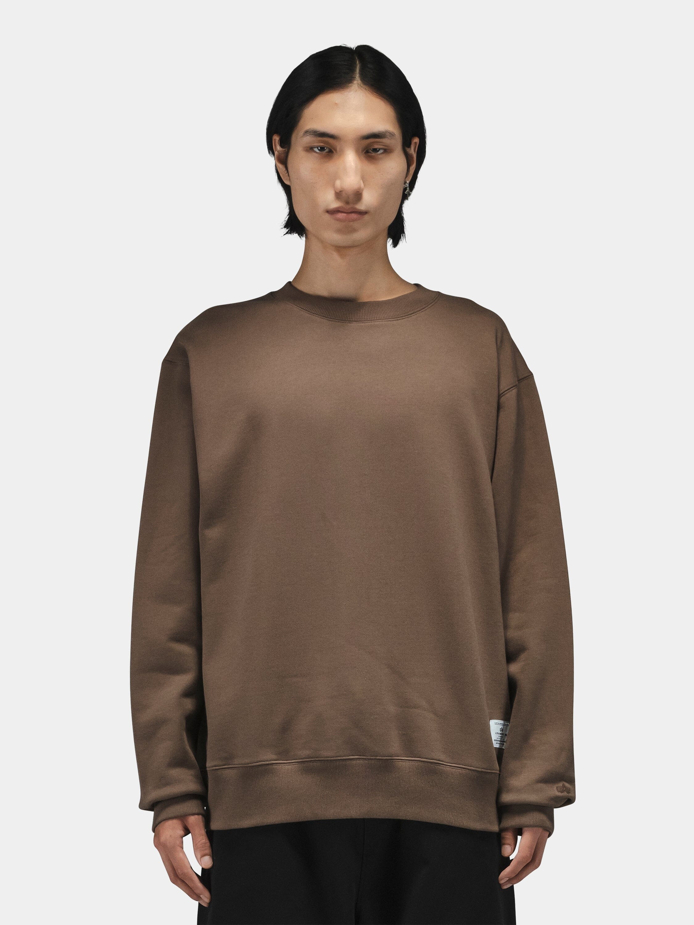 Patched Crewneck by Alpha Industries in black, paired with black pants.