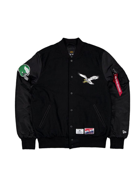 Philadelphia Eagles MA-1 Bomber Jacket by Alpha Industries, black, eagle chest patch, green football helmet sleeve patch, red Remove Before Flight tag, Alpha logo.