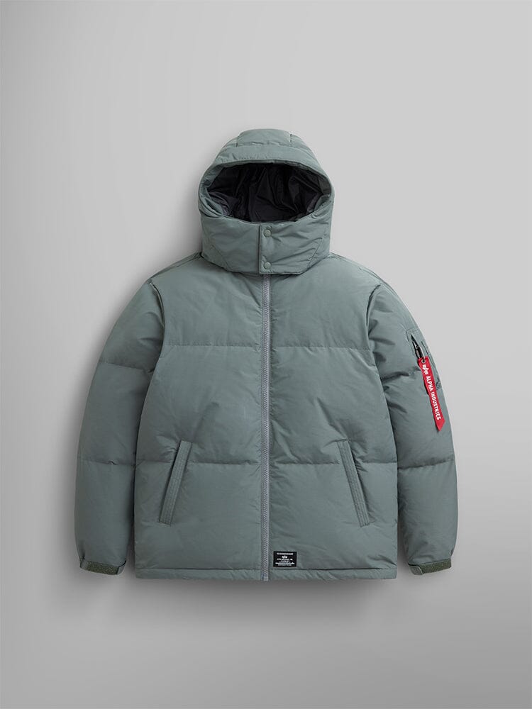 Alpha Industries Puffer Parka in Field Gray, water-resistant fabric, hood, front zipper, two side pockets, red tag on left sleeve.