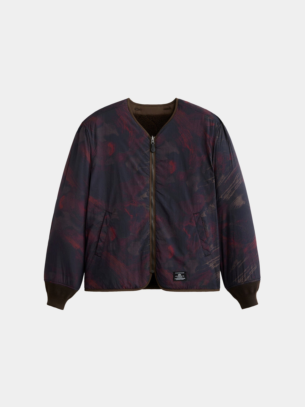 The Alpha Industries Reversible M-65 Quilted Liner, dark patterned bomber jacket with front zipper, side pockets, ribbed cuffs and collar.
