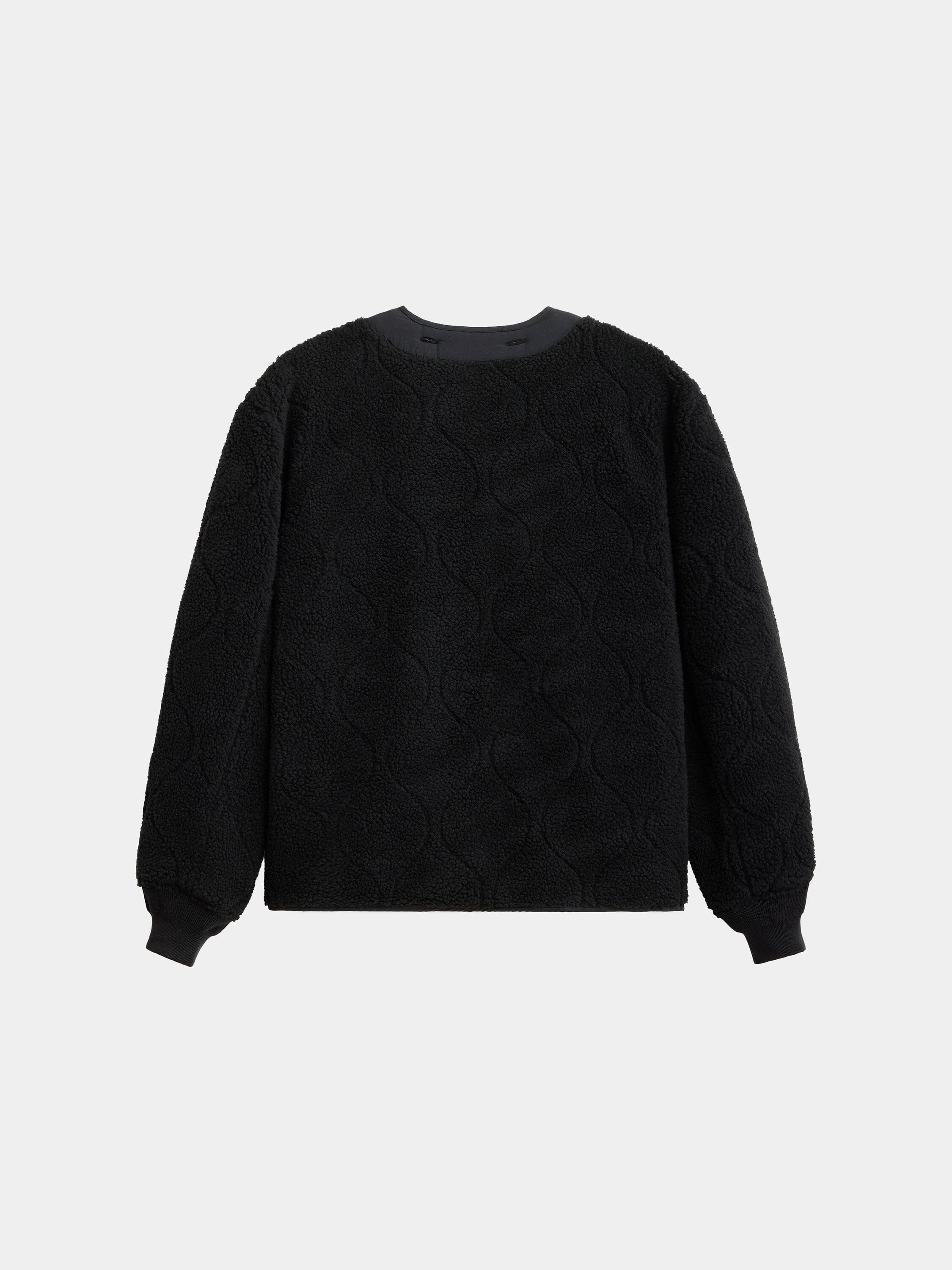 Alpha Industries Reversible M-65 Quilted Liner, black with circular quilted pattern, ribbed crew neck, cuffs, and hem.