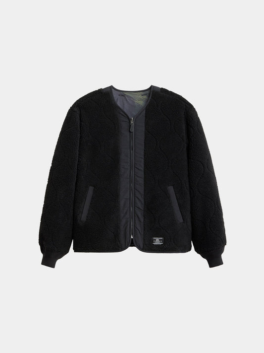 Alpha Industries Reversible M-65 Quilted Liner in black with zip front, long sleeves, quilted texture, ribbed cuffs, side pockets, plain collar.