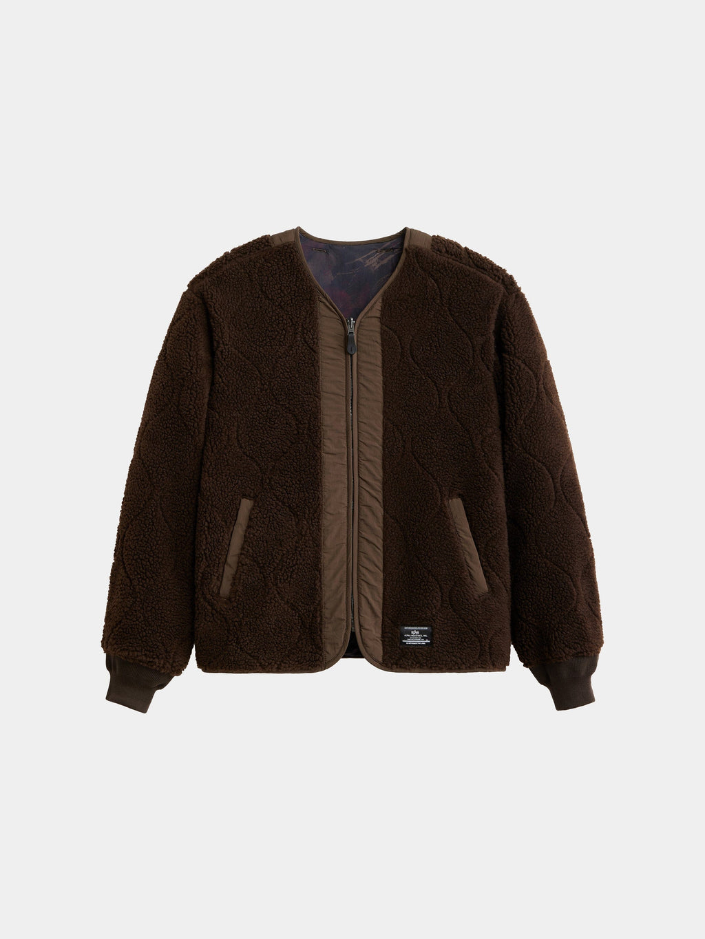 Alpha Industries Reversible M-65 Quilted Liner in Espresso with textured fabric, front zipper, ribbed cuffs, and two side pockets.