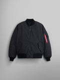 A black Reversible Onion Quilted MA-1 Bomber Jacket by Alpha Industries, featuring a front zipper, ribbed cuffs and hem, and a red tag on the pocket of the left sleeve.