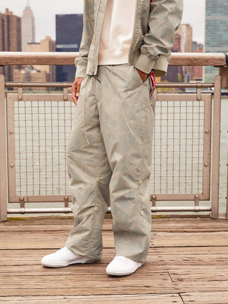 Alpha Industries Lightweight Parachute Pant Frogskin, parachute material, camouflage pattern, elastic waistband, drawstring closure.