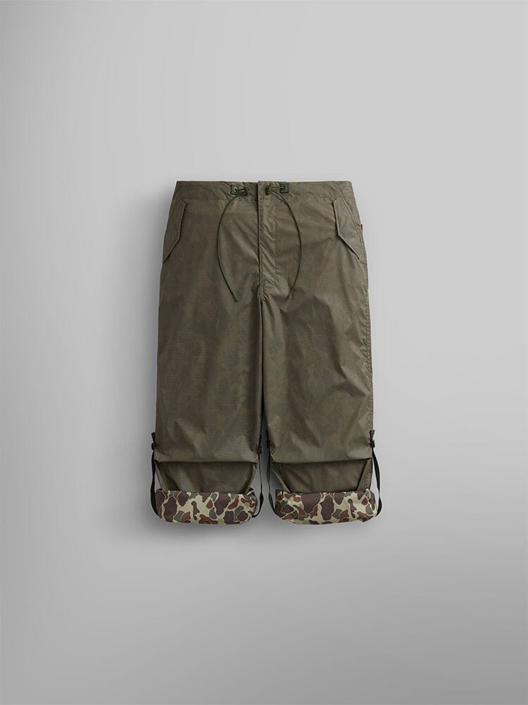 Alpha Industries Lightweight Parachute Pant in olive green with drawstring waist, side pockets, and Frogskin camo print cuffs at the hem.