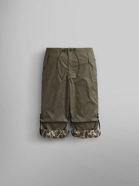 Alpha Industries Lightweight Parachute Pant in olive green with drawstring waist, side pockets, and Frogskin camo print cuffs at the hem.
