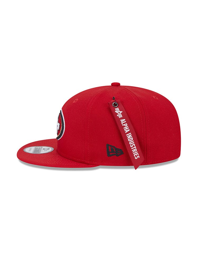 San Francisco 49ers x Alpha x New Era 950 Cap with the team logo embroidered on the front, featuring a red Alpha Industries tag on the side.