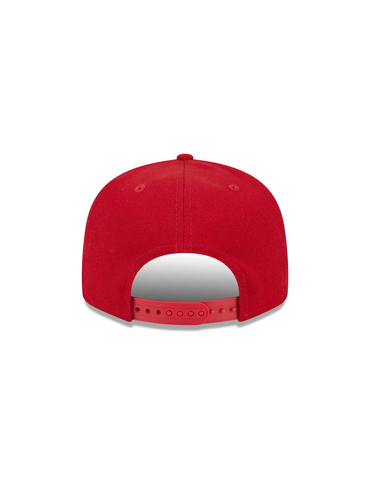 The San Francisco 49ers x Alpha x New Era 950 Cap, designed by Alpha Industries under model FW24-NE-NFL, showcases a bold team logo and features an adjustable strap. The red New Era snapback cap is stylishly depicted from the back.