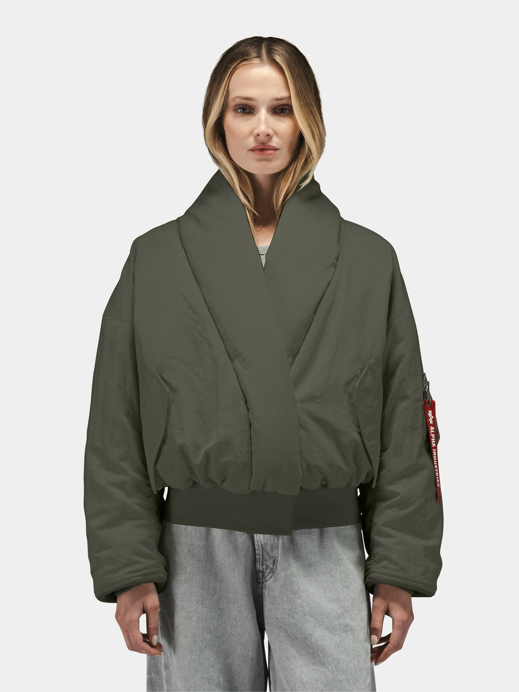 Alpha Industries Shawl Collar Flight Jacket Womens, dark green, down-filled bomber with wide collar and light gray jeans.