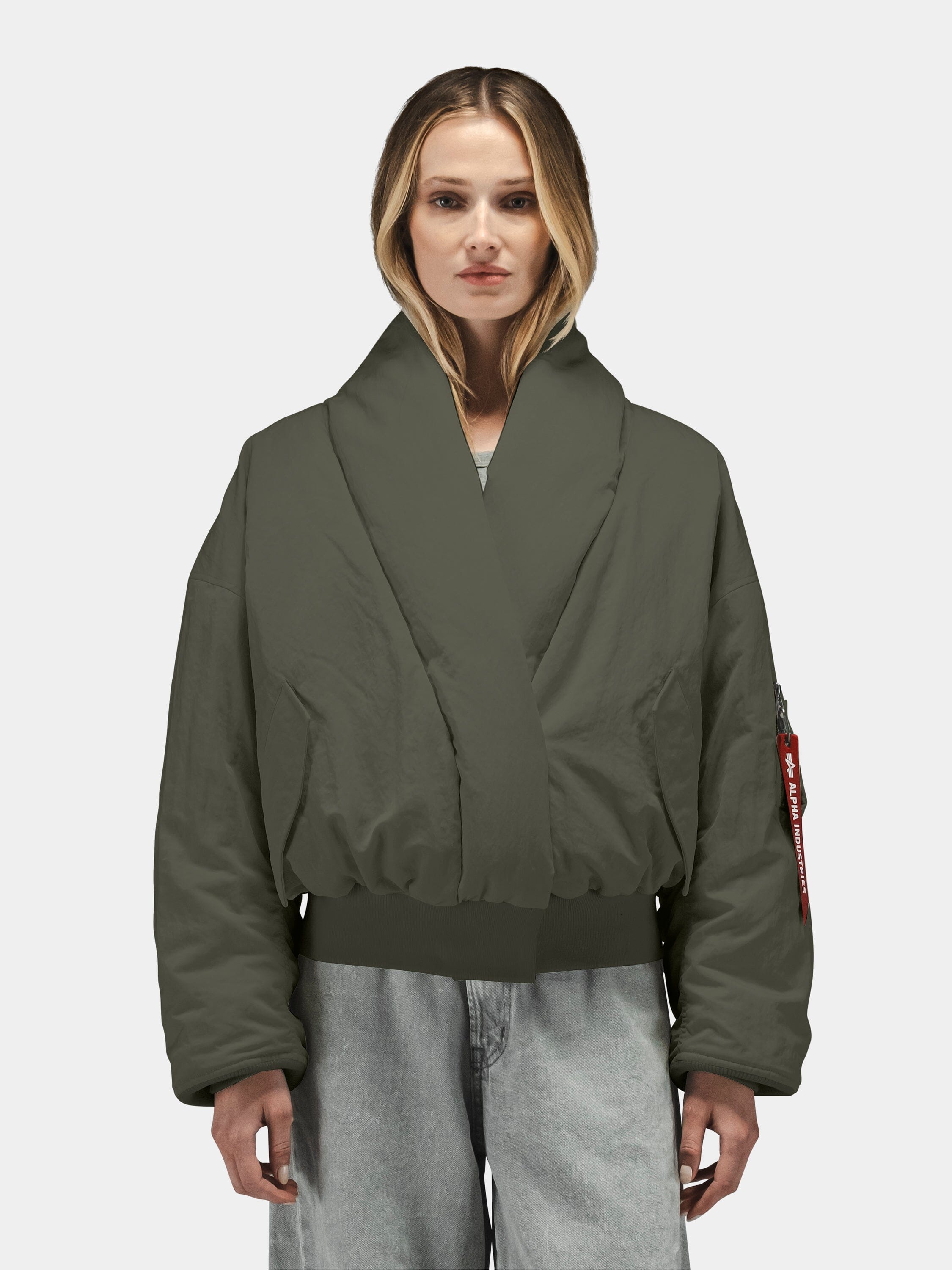 Alpha Industries Shawl Collar Flight Jacket Womens, dark green, down-filled bomber with wide collar and light gray jeans.