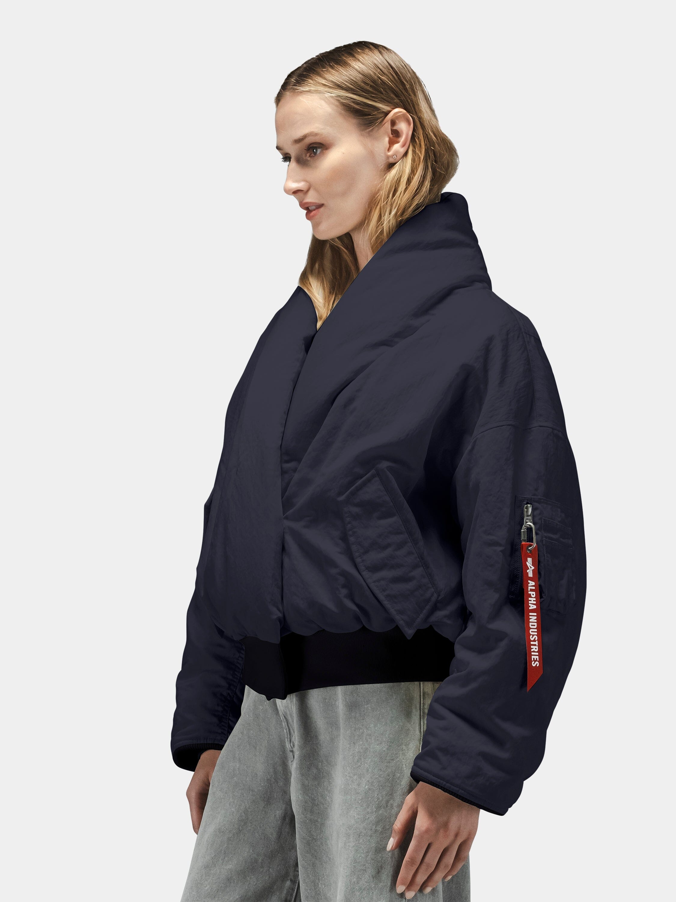 Alpha Industries Shawl Collar Flight Jacket Womens in dark blue with red sleeve tag, light gray jeans.