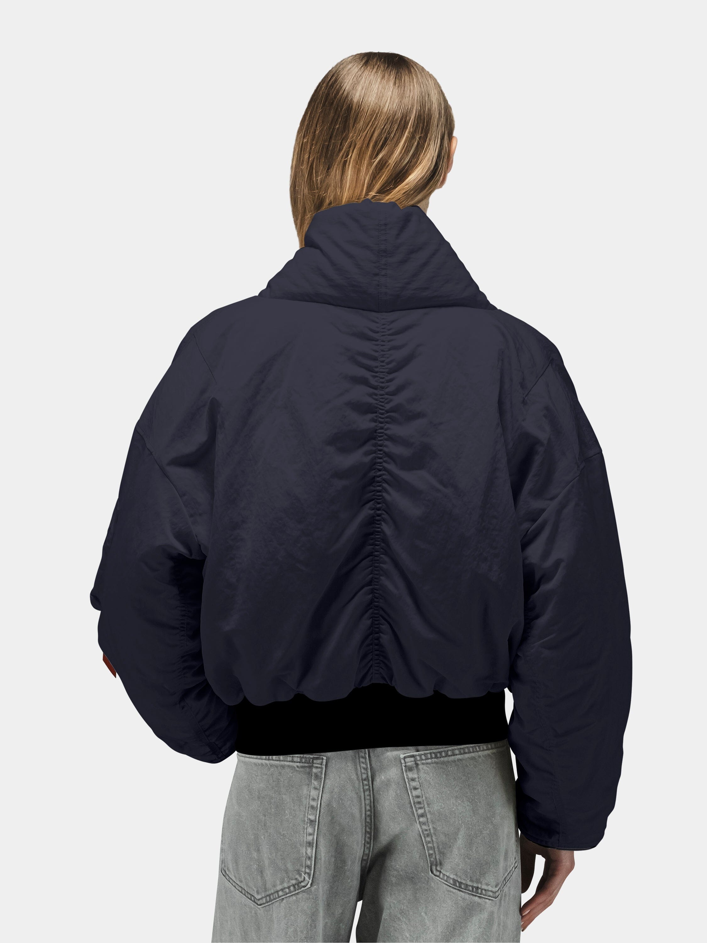 Alpha Industries Shawl Collar Flight Jacket Womens in navy, paired with light gray jeans.