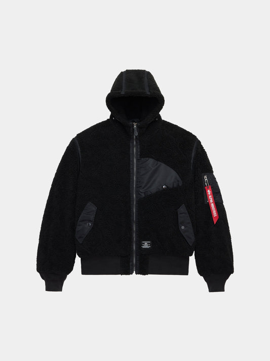 Alpha Industries Sherpa Onion Quilting Flight Jacket in black with sherpa quilting, front zipper, ribbed cuffs and hem, flap pockets, utility sleeve pocket with red tag.