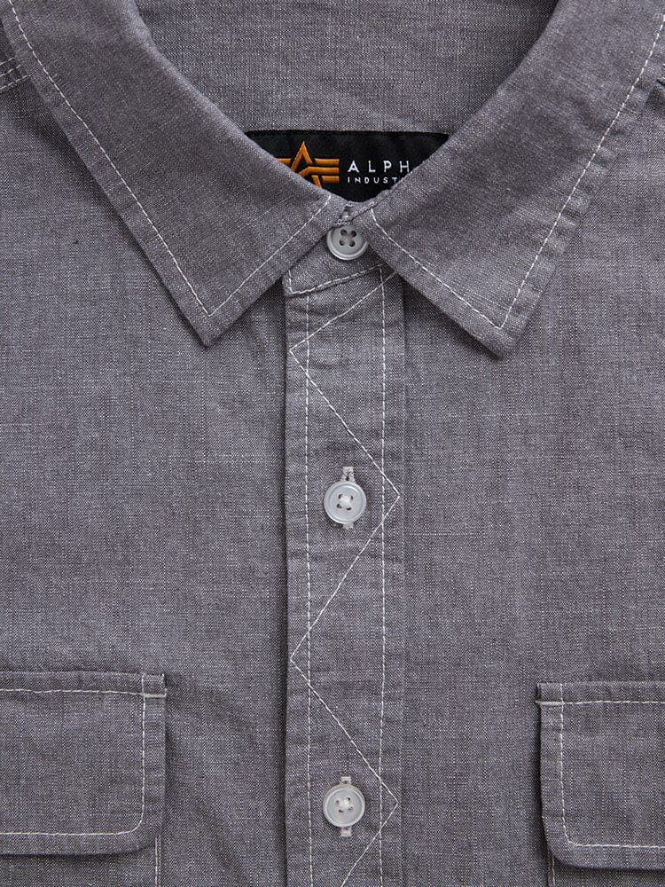 Alpha Industries Short Sleeve Multi Pocket Shirt in gray with flap pockets, white stitching, button closures, and visible brand label inside collar.