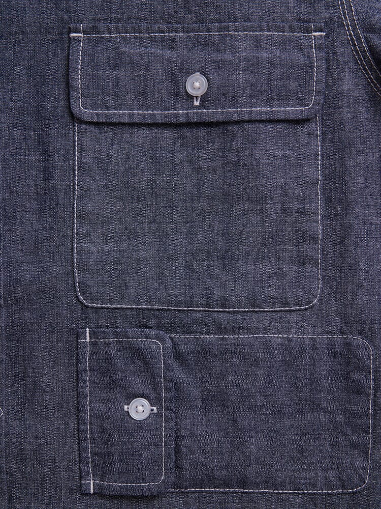 Alpha Industries Short Sleeve Multi Pocket Shirt, dark blue denim, two rectangular flap pockets with button closures, white stitching.