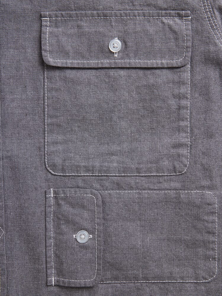 Alpha Industries Short Sleeve Multi Pocket Shirt, gray, two rectangular flap pockets with white button closures, visible white stitching.