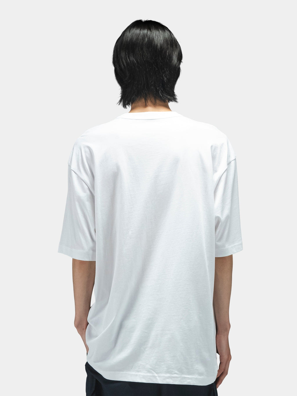 Alpha Industries Short Sleeve Relaxed Tee, dark color, paired with dark pants. Simple tee design.