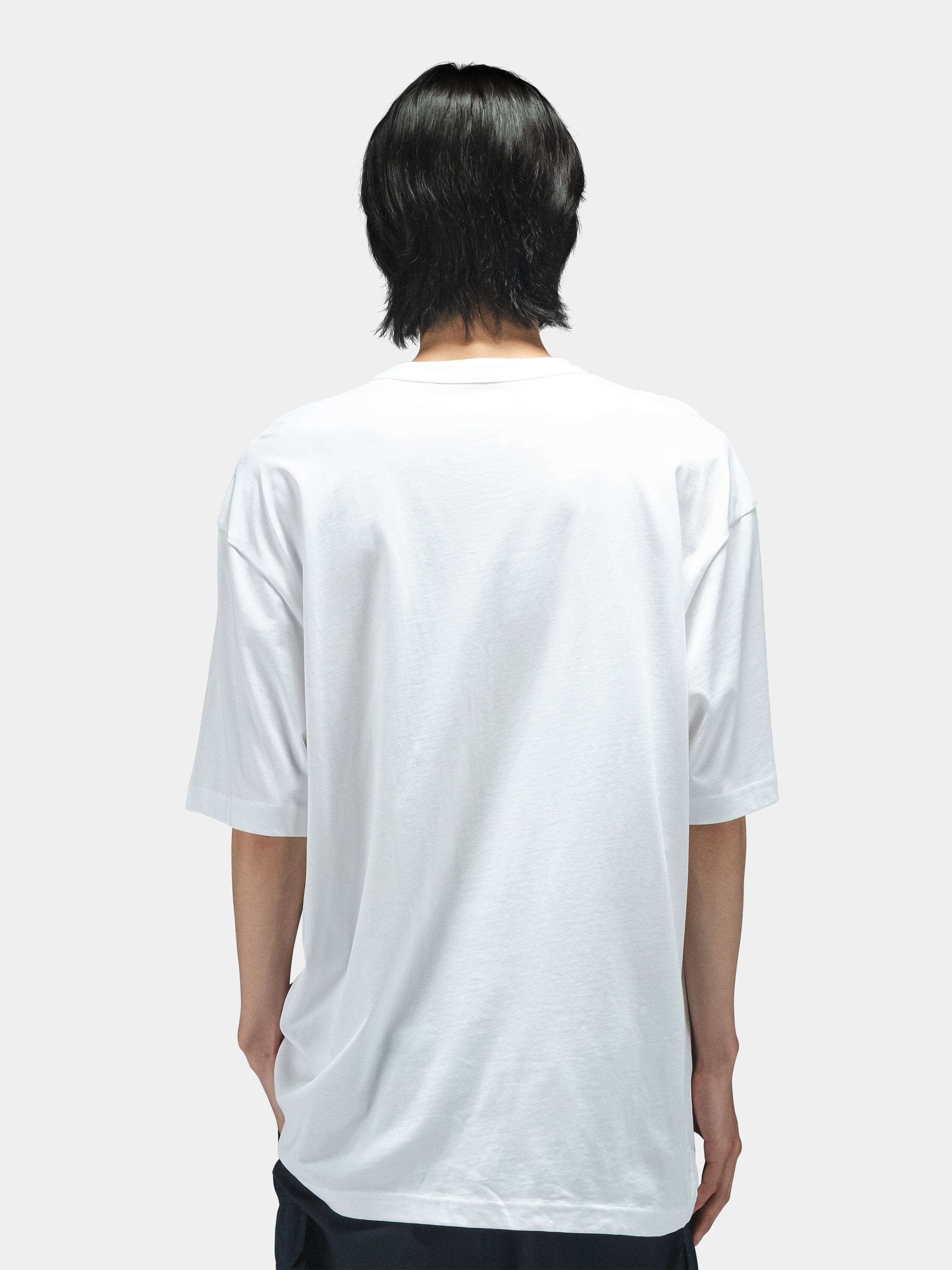 Alpha Industries Short Sleeve Relaxed Tee, dark color, paired with dark pants. Simple tee design.